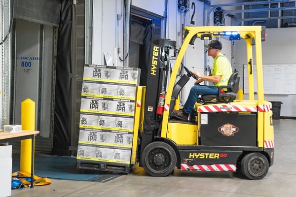 man-riding-a-yellow-forklift-with-boxes-1267324